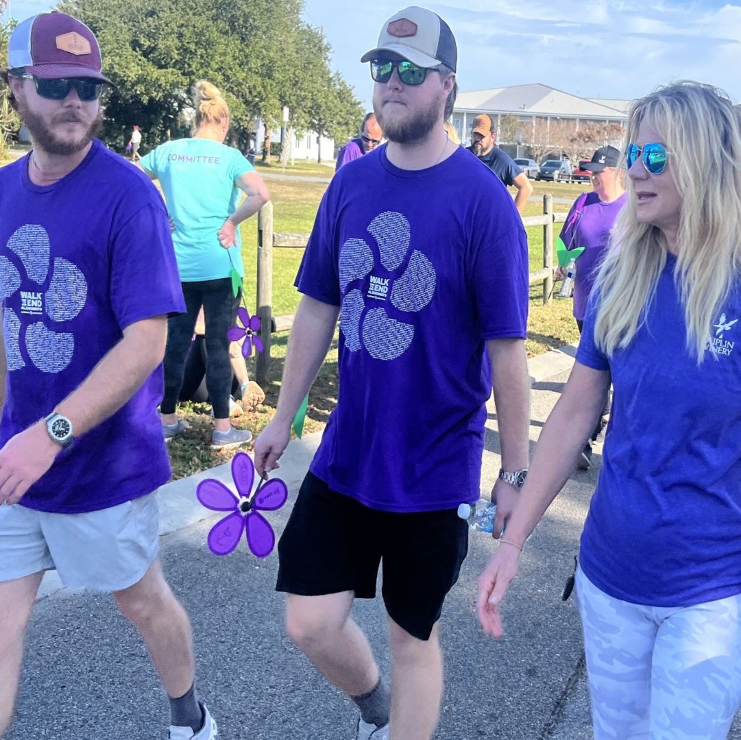 Cousins and Duplin winemakers Case Merritt and Gray Fussell walk with Fussell's mother, Angie Fussell, at the 2024 Walk to End Alzheimer's — Wilmington! on November 2, 2024, in Wrightsville Beach, N.C.