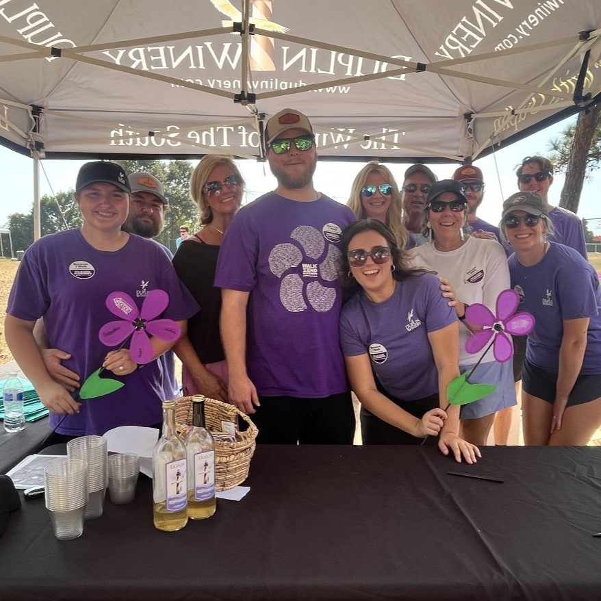 The Duplin Winery team, incluidng Gray Fussell; his wife, Sydney Fussell; and his mother, Angie Fussell, join the Duplin team at the 2024 Walk to End Alzheimer's — Wilmington! on November 2 in Wrightsville Beach, N.C.