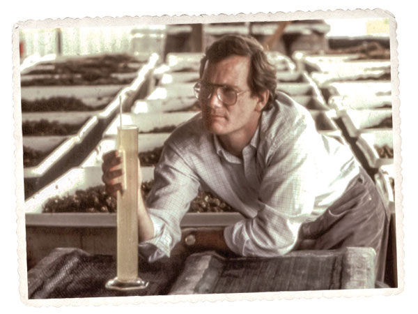 Dan Fussell uses a hydrometer to check the sugar levels of fermenting wine. Dan Fussell uses a hydrometer to check the sugar levels of fermenting wine.